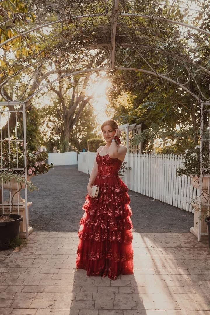 Full length red formal gown under the garden arch at St Aubins Village, Rockhampton